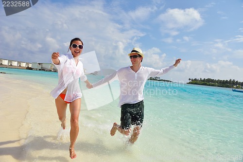Image of happy young couple have fun on beach