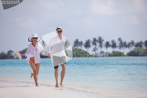Image of happy young couple have fun on beach