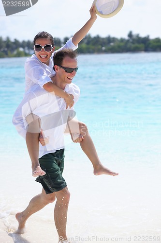 Image of happy young couple have fun on beach