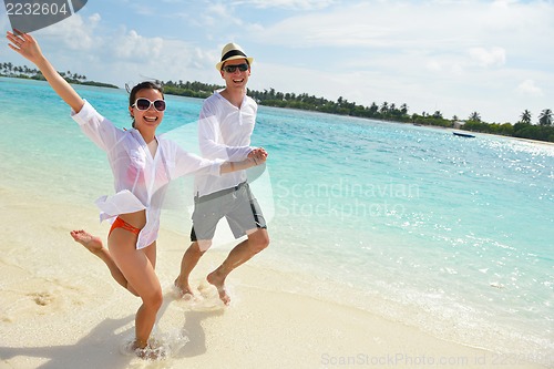 Image of happy young couple have fun on beach
