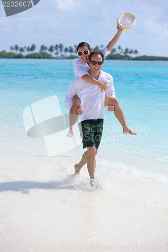 Image of happy young couple have fun on beach