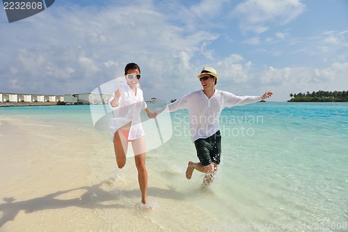Image of happy young couple have fun on beach