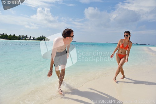 Image of happy young couple have fun on beach
