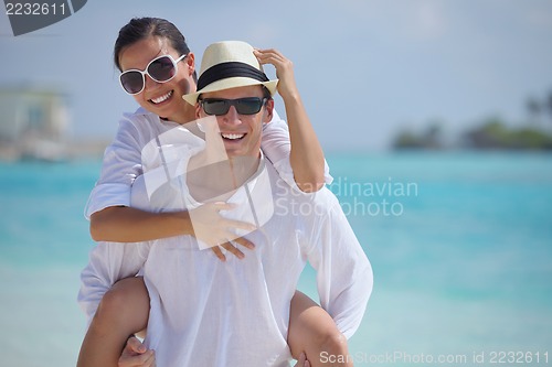 Image of happy young couple have fun on beach
