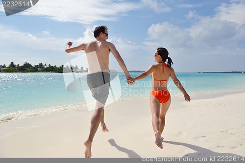 Image of happy young couple have fun on beach