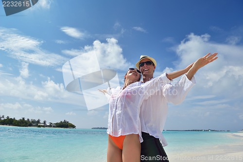 Image of happy young couple have fun on beach