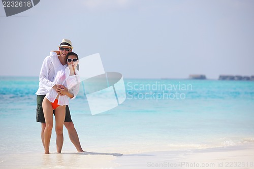 Image of happy young couple have fun on beach
