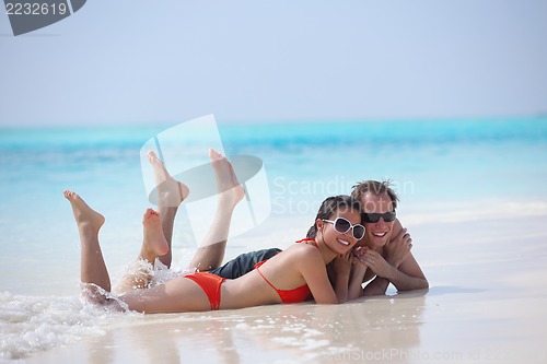 Image of happy young couple have fun on beach