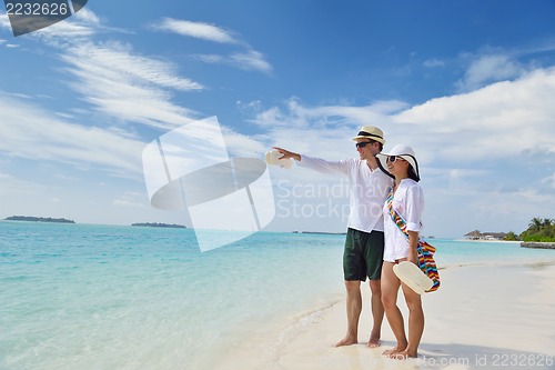 Image of happy young couple have fun on beach