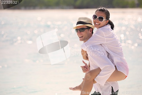 Image of happy young couple have fun on beach