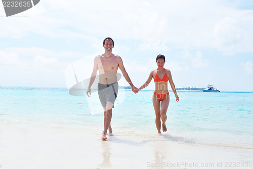 Image of happy young couple have fun on beach