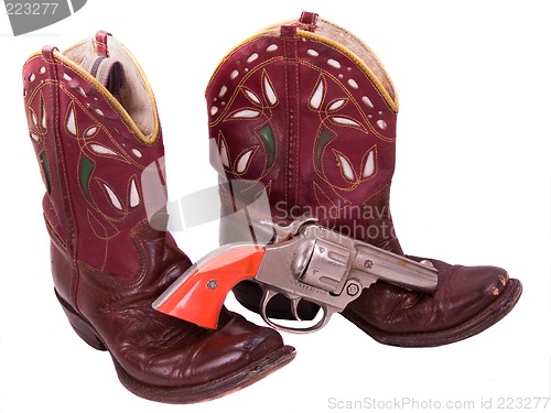 Image of 1950s child's cowgirl boots and cap pistol