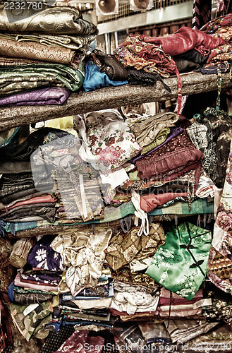 Image of rough stacking of clothing on shelf