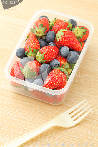 Image of Healthy lunch box with strawberry and blueberry mix in office