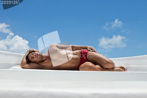 Image of Man sun bathing on o boat