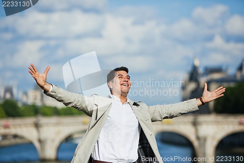 Image of Man smiling with his arm outstretched