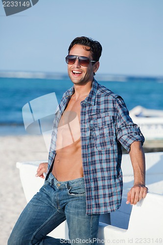 Image of Man wearing sunglasses and enjoying on the beach