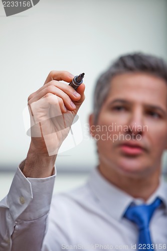 Image of Businessman writing with a felt tip pen