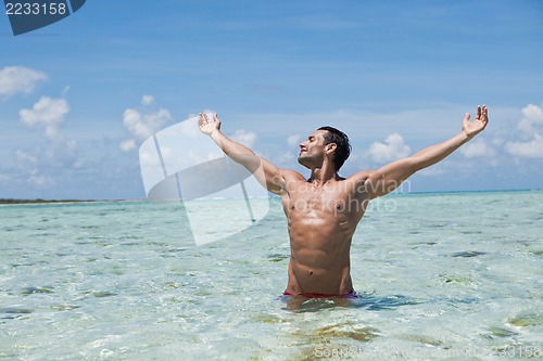 Image of Man enjoying in water on the beach