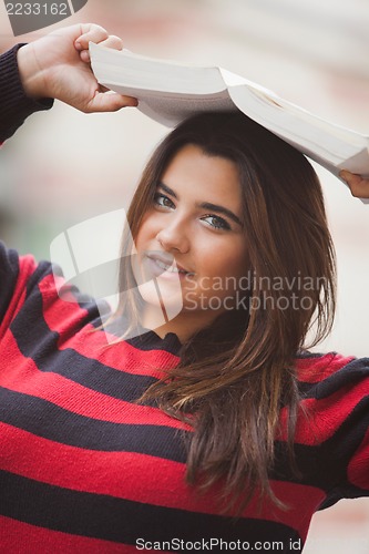 Image of Woman overweight with book on her head