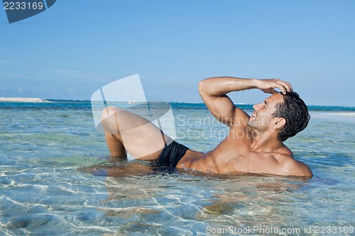 Image of Man enjoying in water on the beach