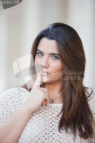Image of Overweight Woman with her finger on her lips
