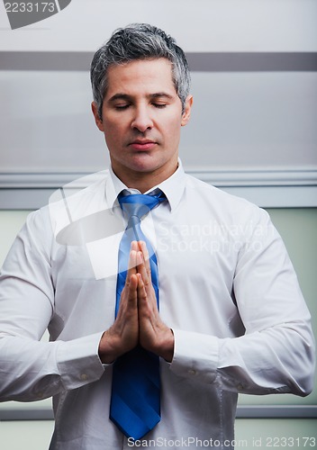 Image of Businessman meditating