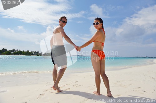 Image of happy young couple have fun on beach