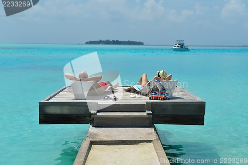 Image of happy young couple have fun on beach