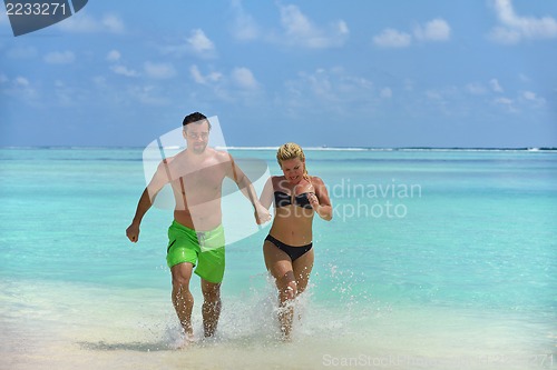 Image of happy young  couple at summer vacation have fun and relax at bea