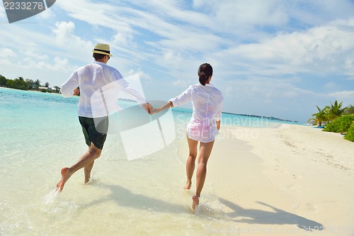 Image of happy young couple have fun on beach