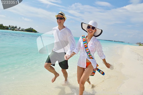 Image of happy young couple have fun on beach