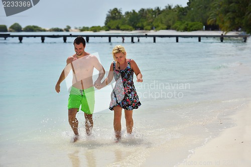 Image of happy young  couple at summer vacation have fun and relax at bea