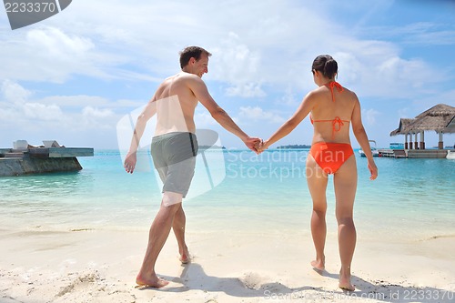 Image of happy young couple have fun on beach