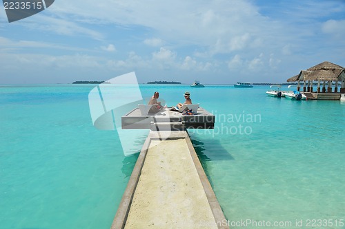 Image of happy young couple have fun on beach