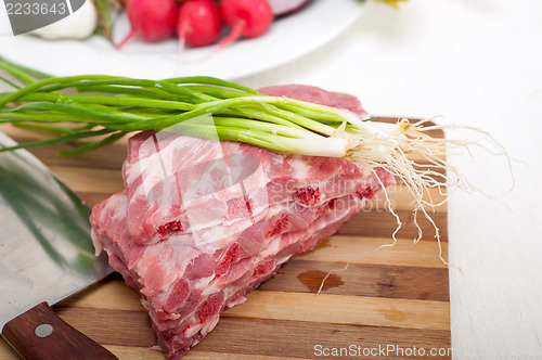 Image of chopping fresh pork ribs and vegetables