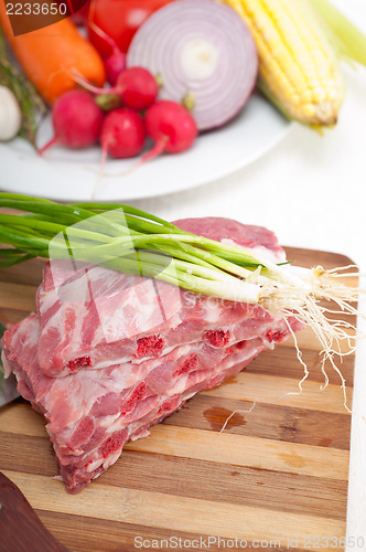 Image of chopping fresh pork ribs and vegetables