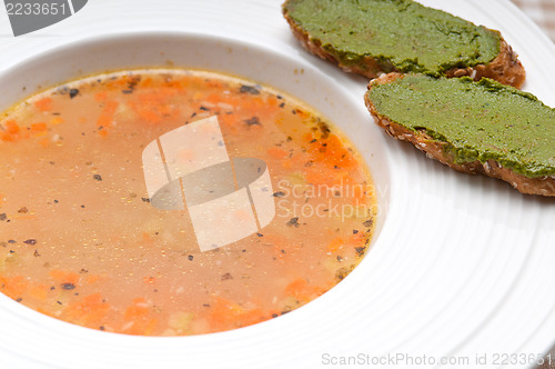 Image of Italian minestrone soup with pesto crostini on side