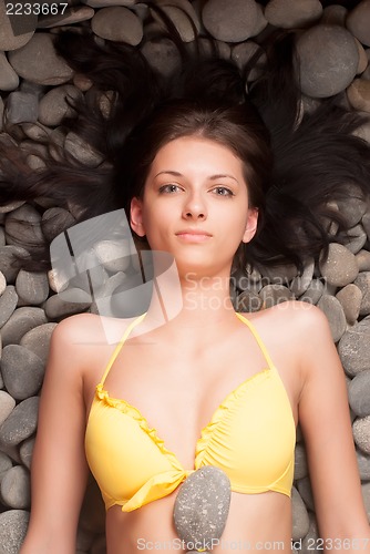 Image of stone massage for young woman
