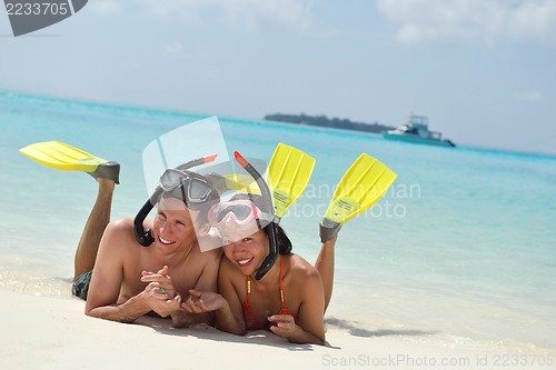 Image of happy young couple have fun on beach