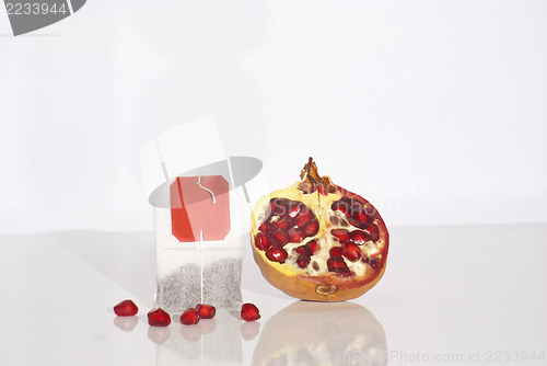 Image of Juicy pomegranate and tea bag