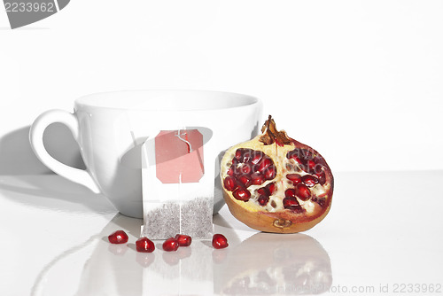 Image of Juicy pomegranate and tea bag