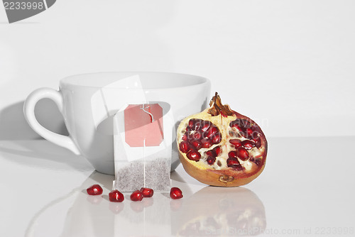 Image of Juicy pomegranate and tea bag