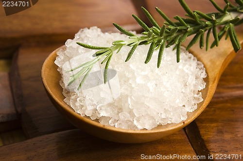 Image of sea salt with rosemary on a wooden spoon