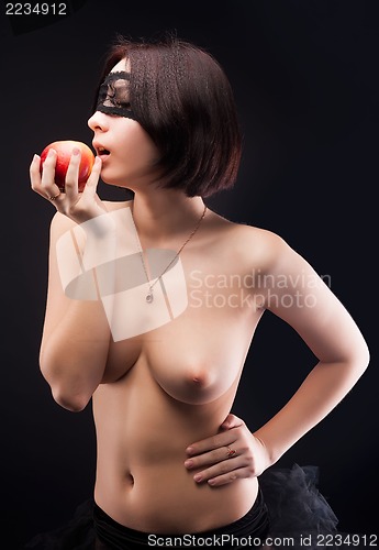 Image of Topless woman offers apple