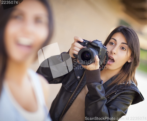 Image of Excited Female Mixed Race Photographer Spots Celebrity