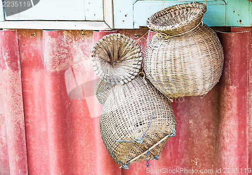 Image of Handmade wicker baskets for fish hanging on wall 