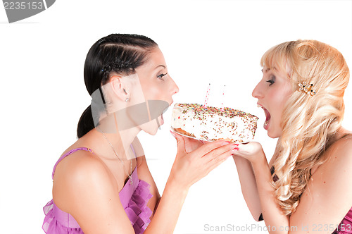 Image of Two girls eating the cake