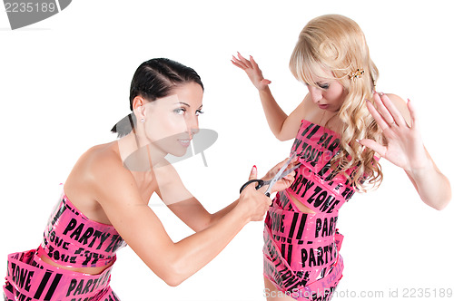 Image of Two girls in pink tape dresses