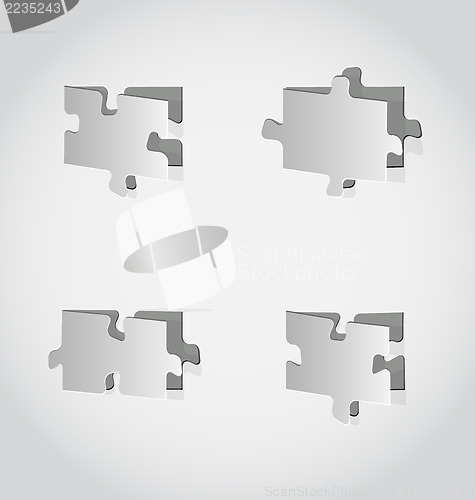 Image of Cut out set puzzle pieces, grey paper